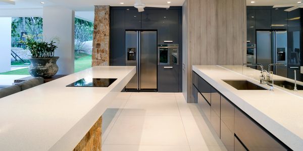 Modern kitchen with sleek countertops and stainless steel appliances.