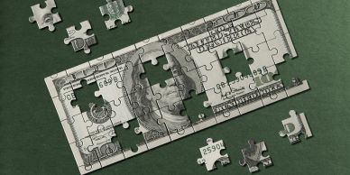 Partially completed puzzle of a US hundred-dollar bill with pieces missing.
