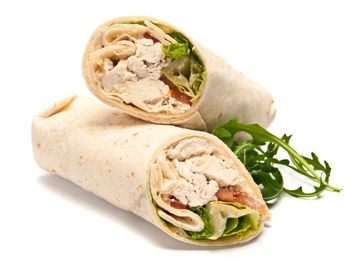Two chicken wraps with lettuce and tomato on a white background.