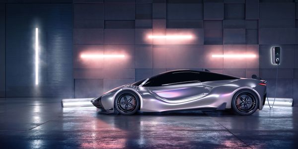 Sleek silver electric sports car charging in a futuristic garage with neon lights.