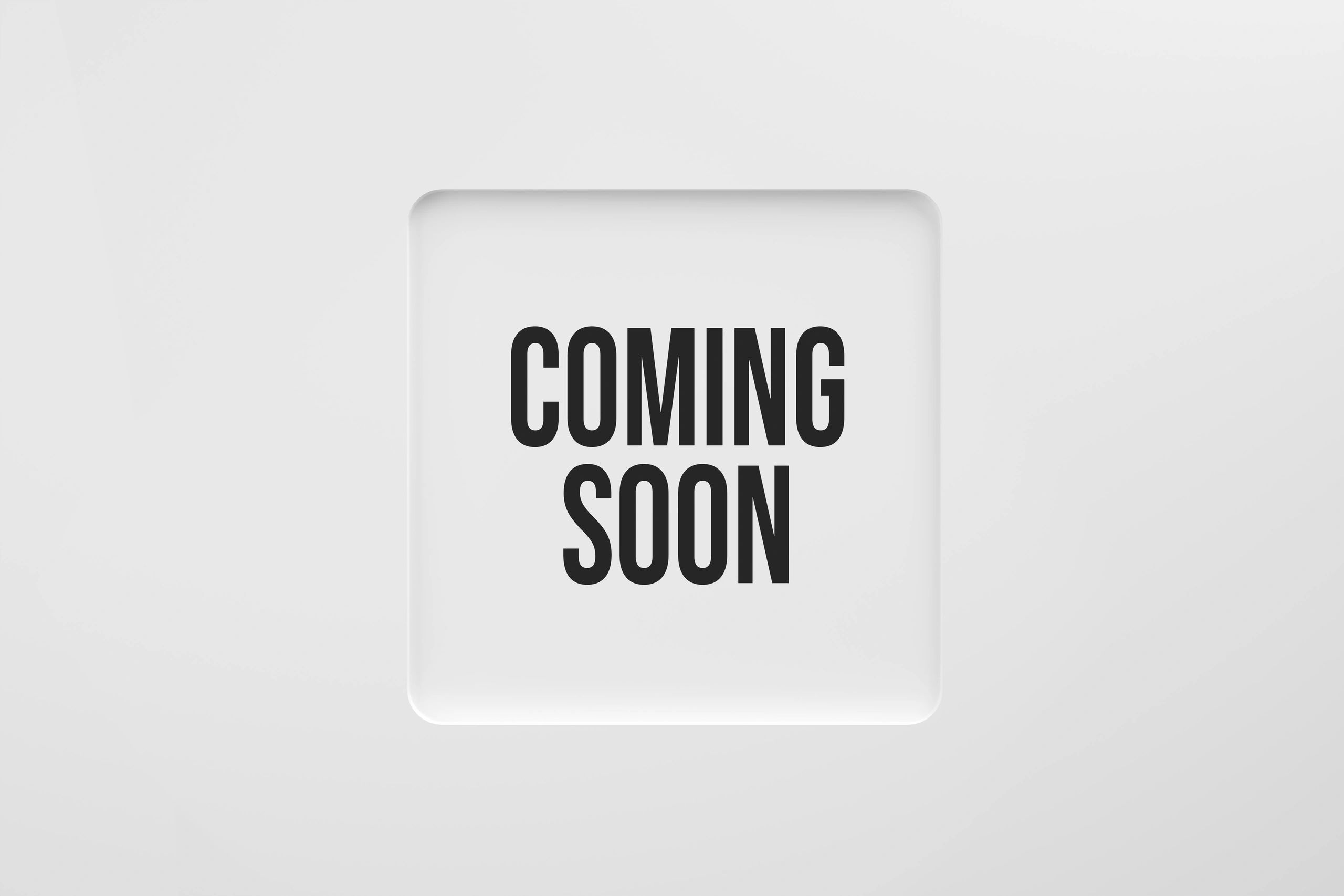 White card with bold black text saying "COMING SOON" on a white background.