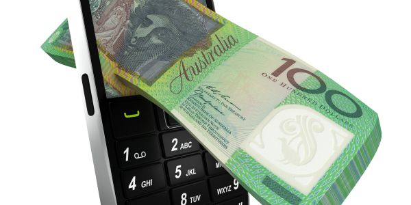 Australian 100-dollar note emerging from a mobile phone keypad.