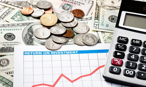 Coins, cash, calculator, and ROI graph showing investment growth.