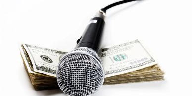 Microphone on a stack of US dollars.