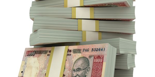 Stacks of Indian 1000 rupee currency notes bundled together.