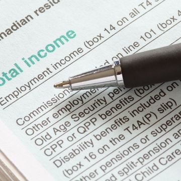 Close-up of a pen on a tax form section titled 'Total Income'.