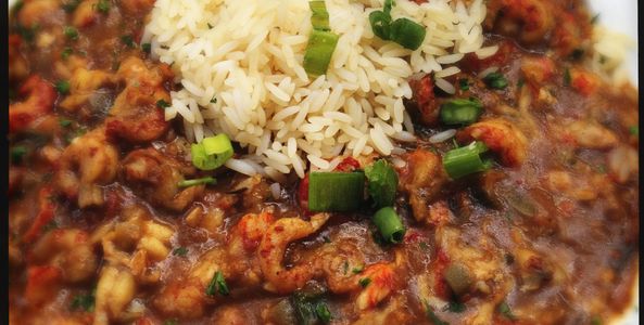 Close-up of shrimp gumbo with rice and green onions.