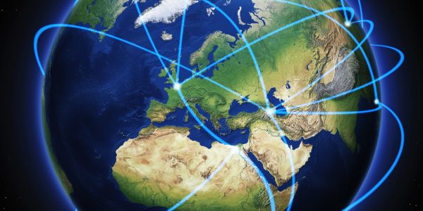 Glowing blue network lines connecting various points across Europe, Africa, and Asia on a globe.