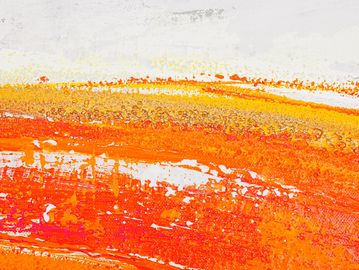 Abstract orange and yellow paint strokes on a white background.