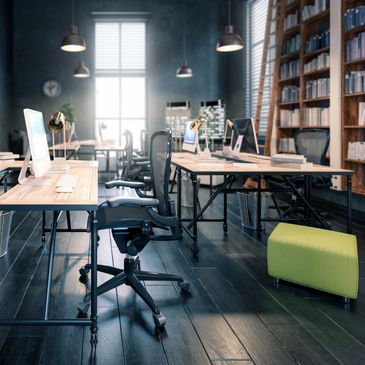 Modern office with sleek desks, ergonomic chairs, and natural light from large windows.