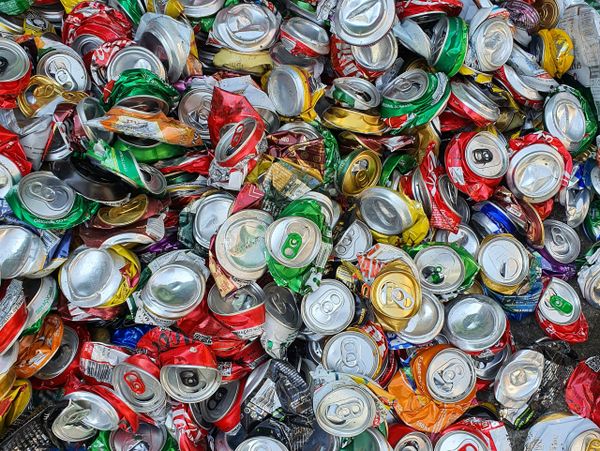 Pile of crushed colorful aluminum cans ready for recycling.