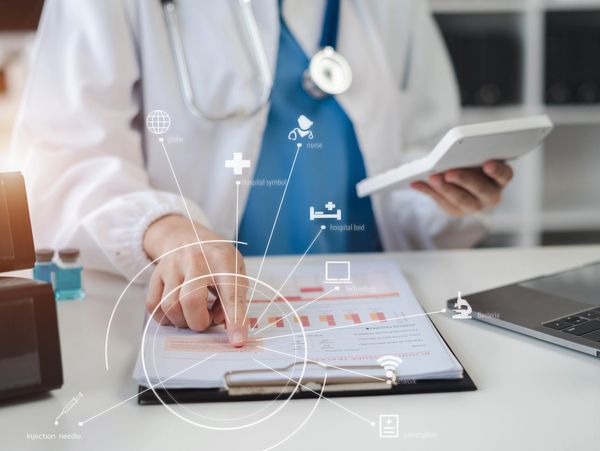 Doctor analyzing medical data with futuristic healthcare icons overlay.