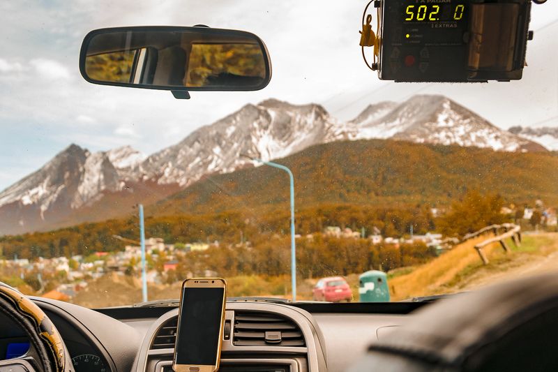 Snowy andes mountains landscape scene from car point of view shot, ushuaia, tierr del fuego, argentina
