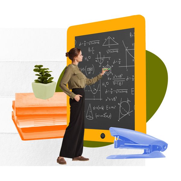 Woman solving math problems on a giant tablet chalkboard with office supplies around.