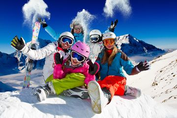 Group of friends enjoying skiing in the snowy mountains.