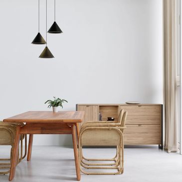 Minimalist dining area with wooden furniture and pendant lights.