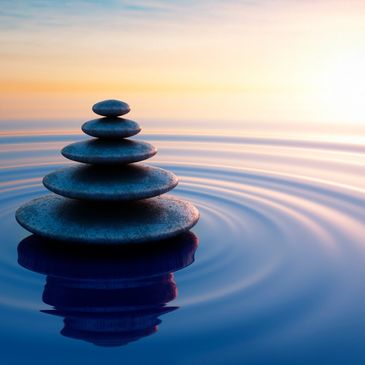 Image of stacked rocks in water.