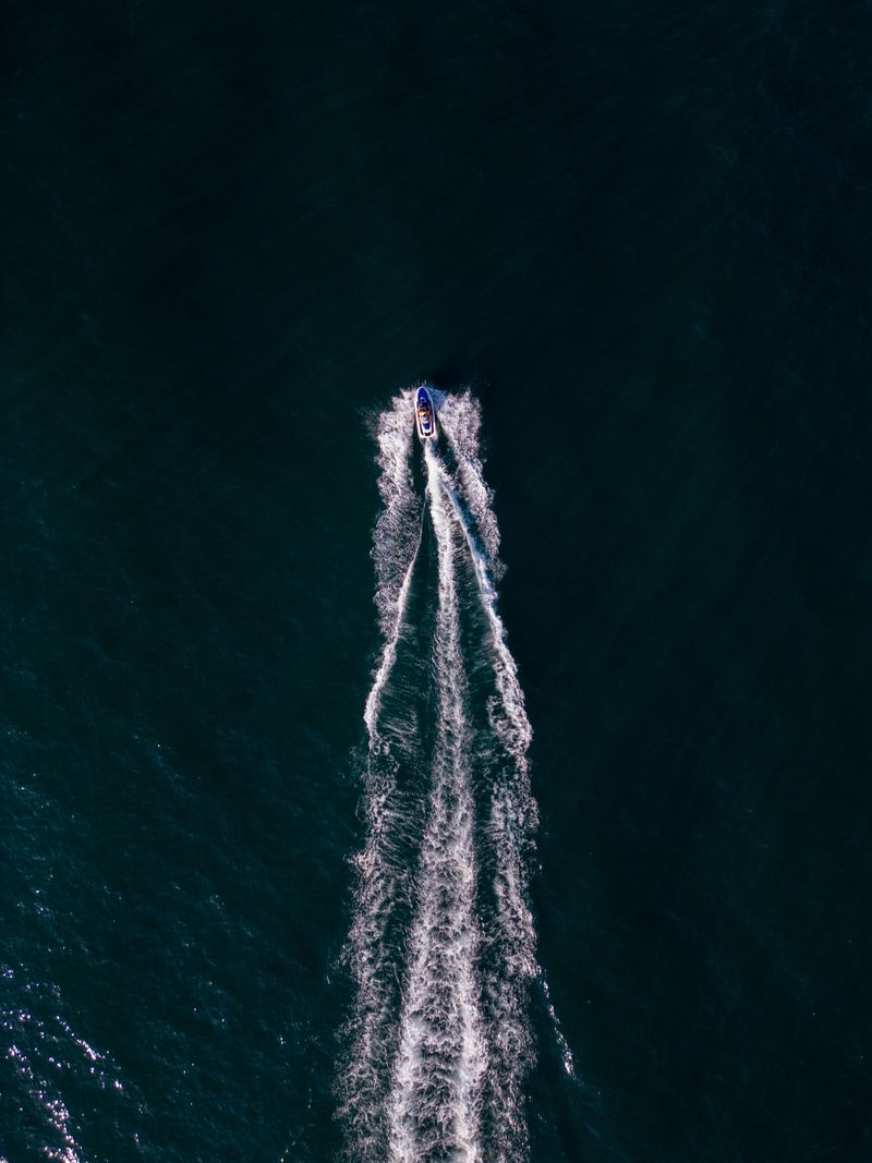 aerial dynamic view of the water scooter or personal watercraft or ski jet racing through the sea waves