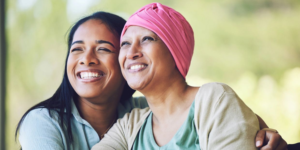 Caregiver smiling with cancer patient making her feel happy Angelic Care Living