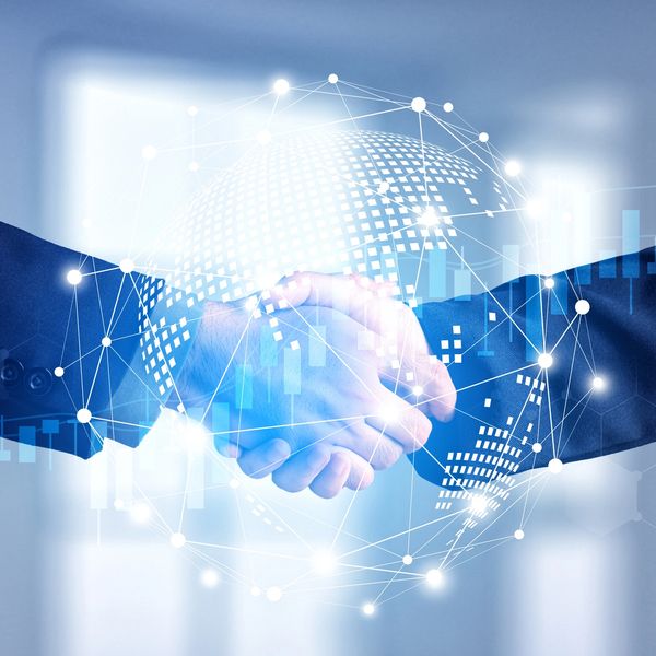 Business handshake with digital globe overlay representing secure IT partnerships and client collab.