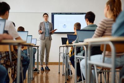 Classroom with students using laptops. 