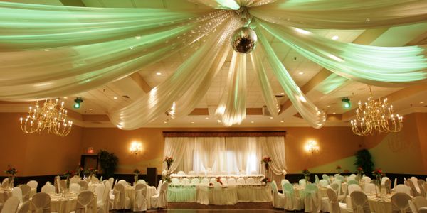 Elegant banquet setup with roses, candles, and golden accents.