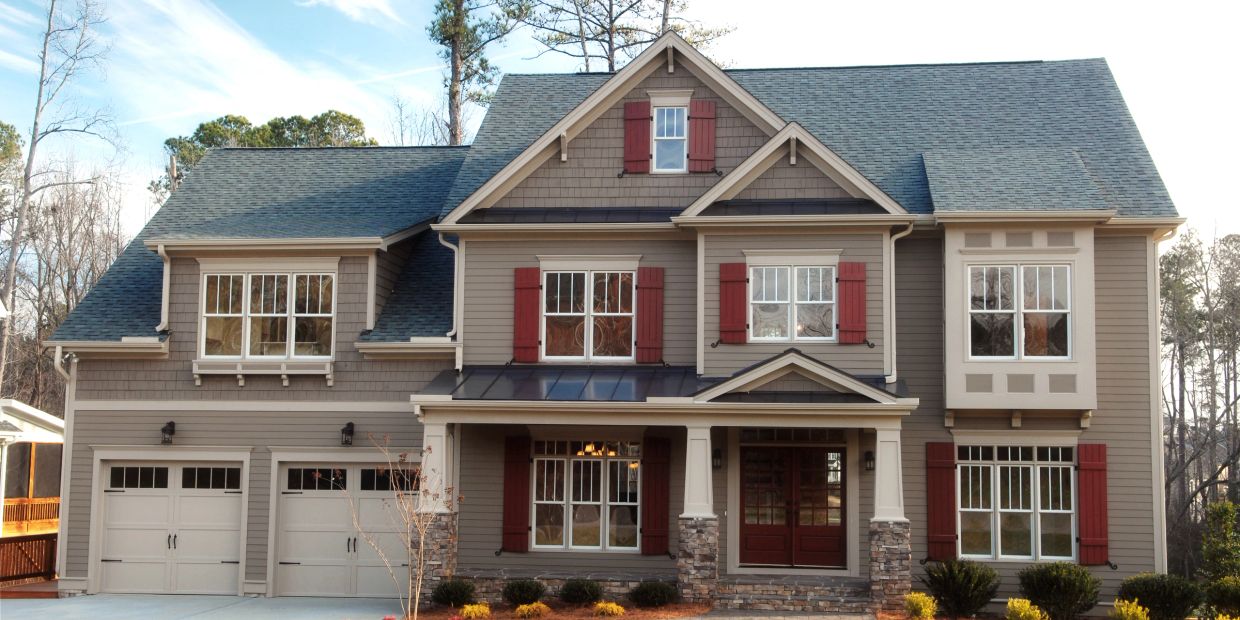 Traditional Smithfield home with carriage-style garage doors representing professional garage door r