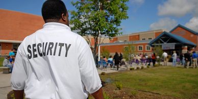 Security guard overseeing an outdoor school event.