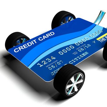 Blue Hyundai Kona parked outdoors beside a white vehicle.