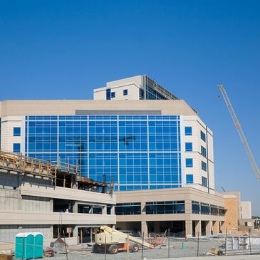 Modern building under construction with blue windows.