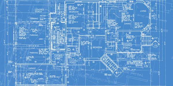 Hands of professionals discussing architectural blueprints on a table.