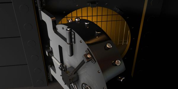 Open vault door revealing empty interior with security bars.
