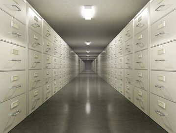 Endless rows of filing cabinets creating a symmetrical corridor.