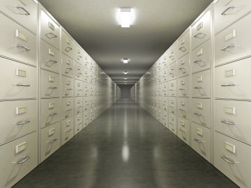 Endless rows of filing cabinets creating a symmetrical corridor.