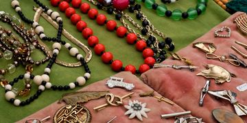 Colorful beaded necklaces and various jewelry on display.