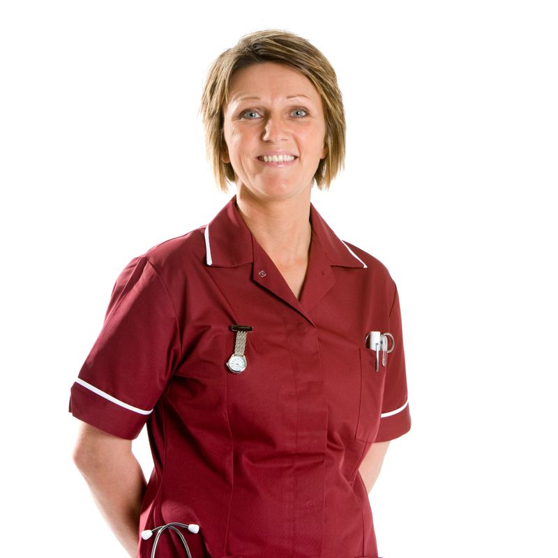 A bright and happy portrait of an attractive mid-adult female nurse in uniform.