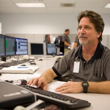 Man working at a computer in a modern office environment.