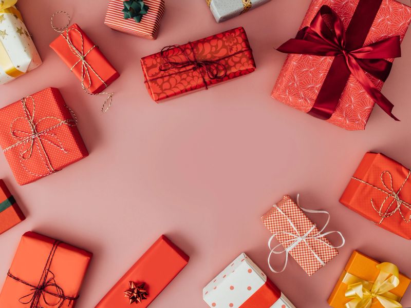 Giving is receiving: A from above view of beautiful presents tied with ribbons. (studio shot, pink background)