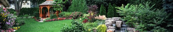 Garden features masonry, dry stack stonewall repair, native plant material, and furniture selection and installation