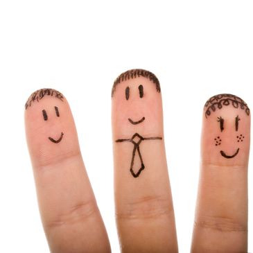 Three fingers with faces and hair drawn on them.
