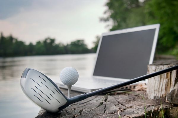 Golfer practicing swing analyzed with V1 Pro software on driving range.