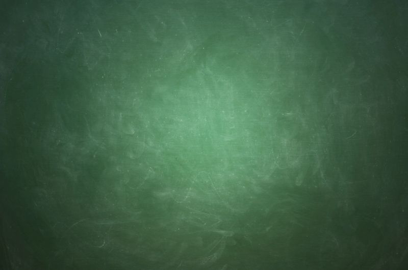 blank green colored blackboard, partially lit