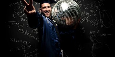 Graduate celebrating with disco ball and peace sign.