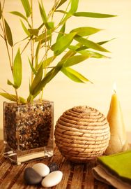 A serene arrangement with bamboo, stones, and candles for relaxation.