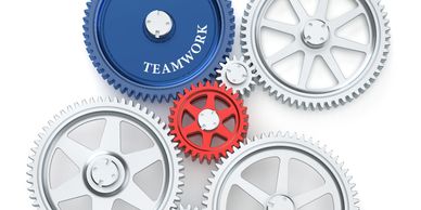 Interconnected gears with a blue one labeled 'TEAMWORK'.