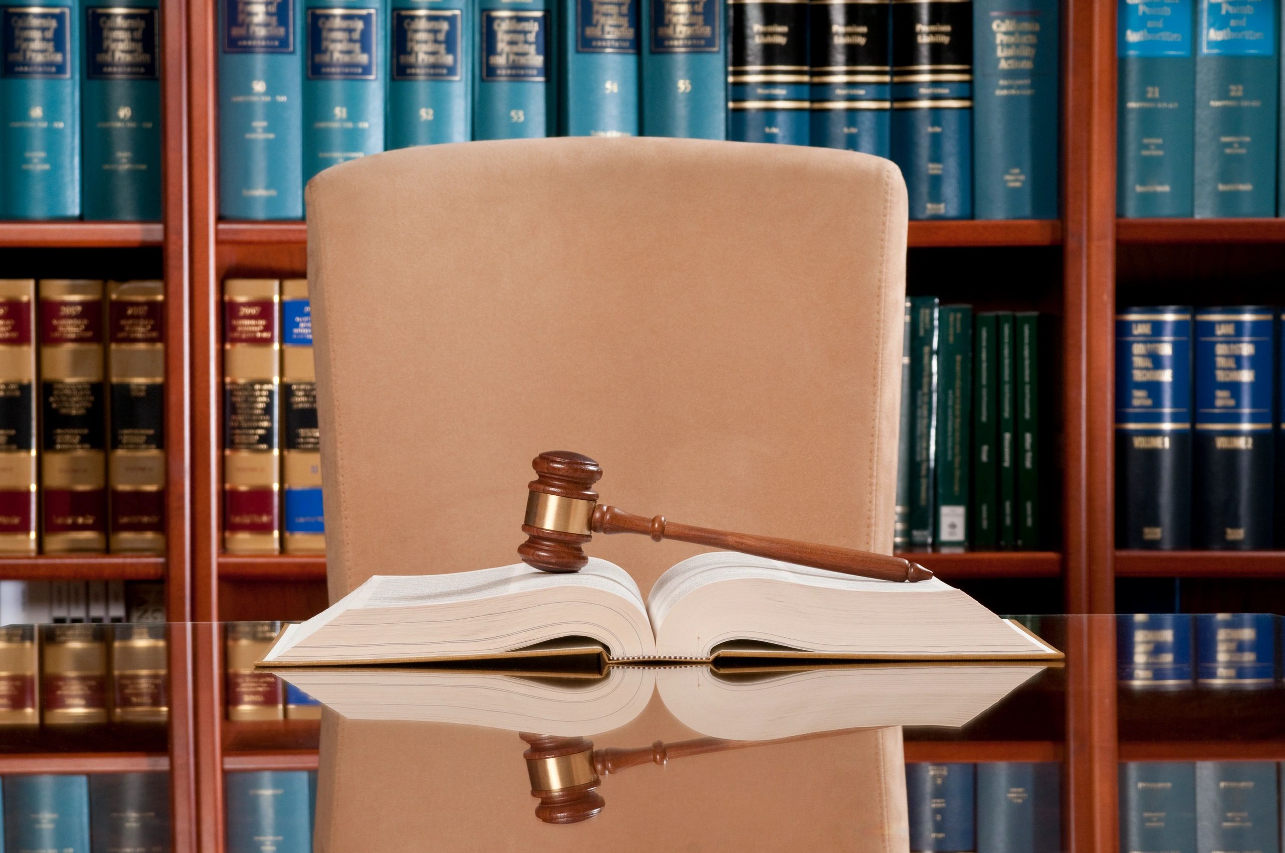 Judge's gavel resting on an open law book in a legal office.