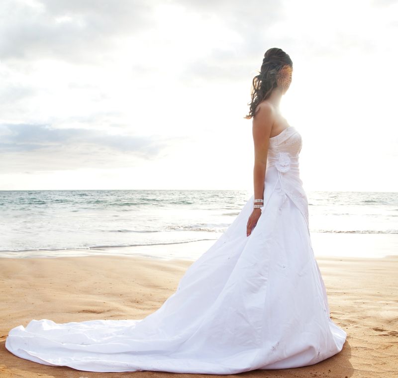 Bride on beach.Lens flare.
