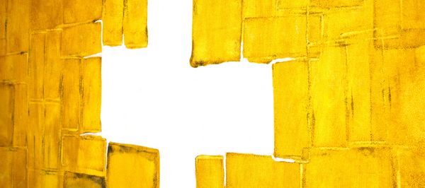 Abstract yellow blocks with a white cross-shaped gap in the center.