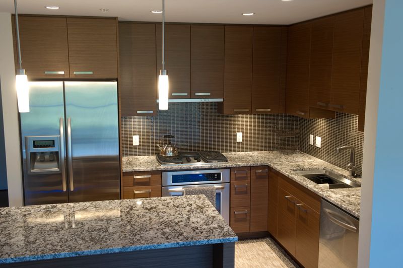 Modern luxury kitchen featuring granite counter tops and stainless steel appliances