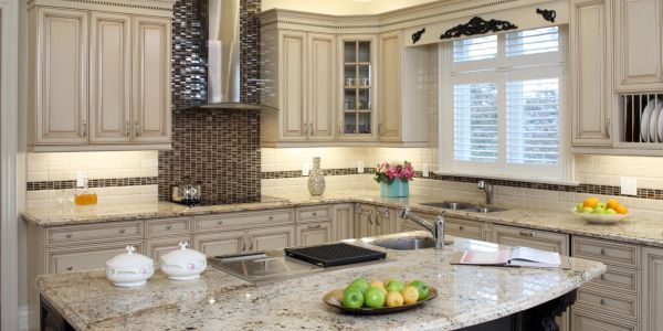 Elegant kitchen showcasing marble countertops and gold accents.